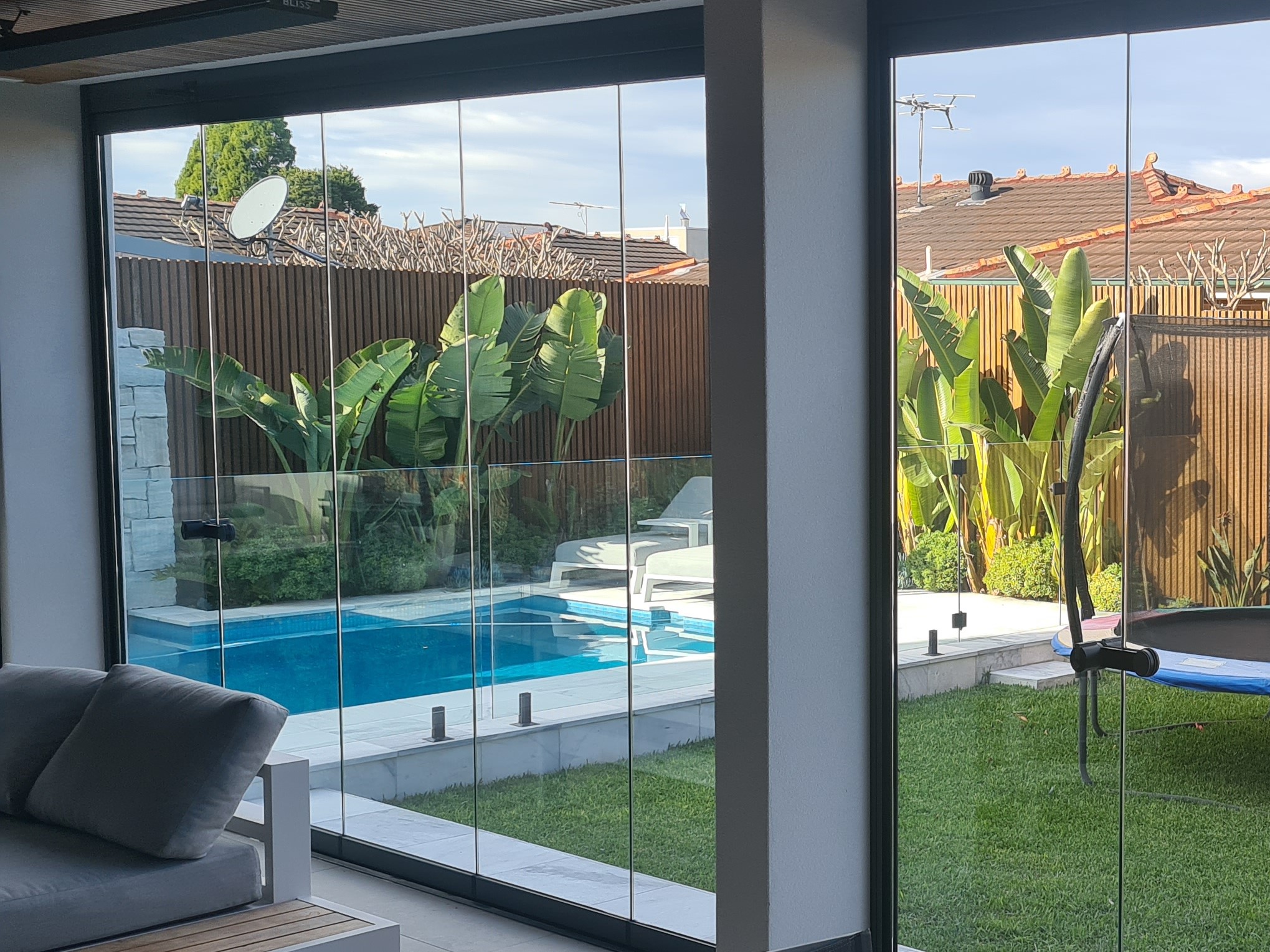 Alfresco with glass doors with pool Alfresco enclosure with glass doors with pool