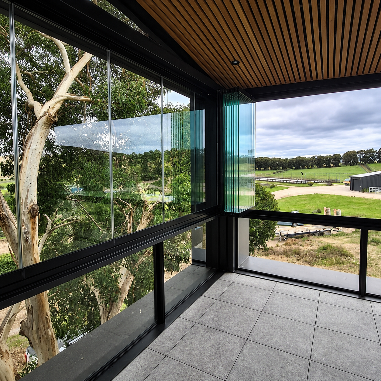 Glass balcony screens on balustrade.